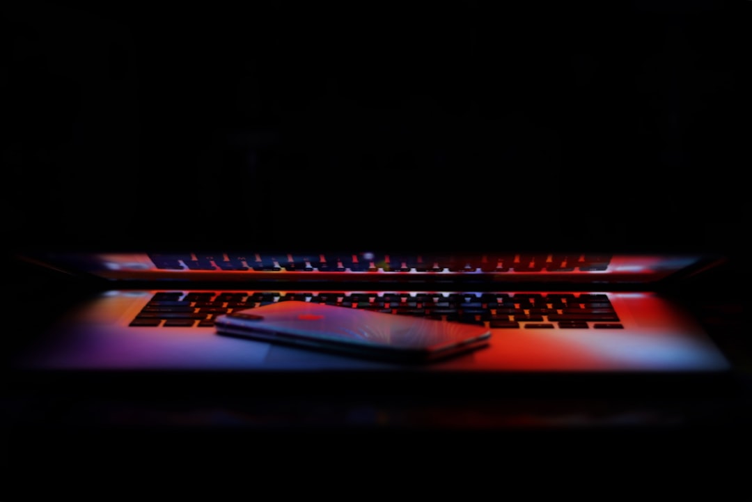 laptop buying checklist india - silver iPhone X on a slightly closed MacBook Pro keyboard
